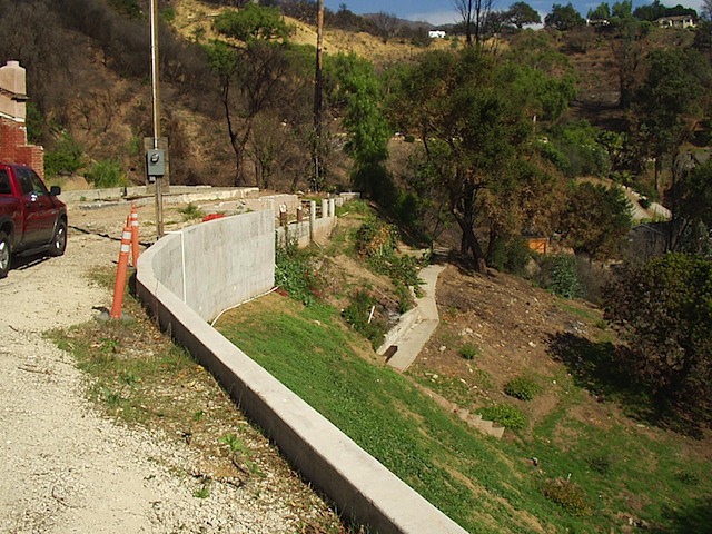 New Retaining Wall with Caissons and Tiebacks after Landslide